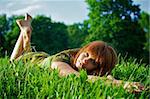 Young beautiful woman lying on green grass