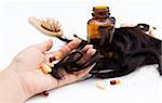 Close-up of a hand with pills and loss hair.