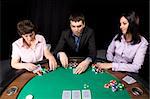 Company of friends having fun in the casino poker table