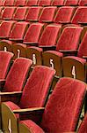 Red cinema or theatre seats, white numbers on wooden part