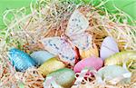 Assortment of chocolate Easter eggs wrapped in colorful paper with butterfly on top