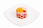 Cake with a cherry and an orange on a white plate