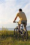 Man riding his bicycyle at the sea in the morning