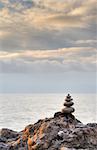 Pebble and stones on a background of the drama sky. Coast of the black sea Crimea, Ukraine