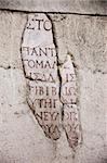 A close up shot of ancient greek writing on a wall