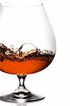 Snifter glass of cognac on white background.