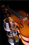 Snifter glass of cognac and violin