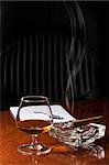 Snifter glass of cognac and cigar