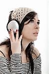 Young beautiful woman listening to music with headphones