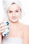 Woman in towel with a cup of tea in her hand