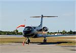 Black corporate jet parked on the ground