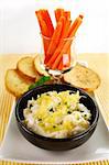 Pineapple ricotta spread with julienne carrots and crisp toasts.