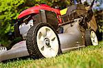 detail of classic Lawn Mower on green grass background