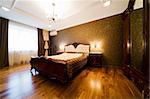 Bedroom with the chandelier in modern apartment