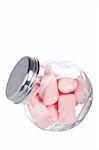 Pink marshmallows in the glass jar, isolated on white background