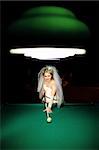 bride playing billiard at night