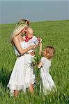 happy mother with two children in traditional clothes outdoors