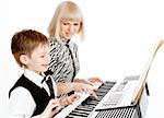 Happy mother and son playing electric piano