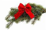 Red gift ribbon on fir tree branch on a white background. Close up. Christmas decoration.