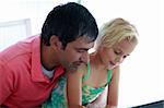 Father and daughter playing with a laptop at home