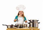 Little girl having fun playing cooking dressed as a chef - isolated