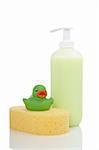 Rubber duck, plastic pump soap bottle and sponge reflected on white background