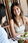 A young woman enjoying a meal at outdoor restaurant