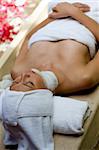 A young woman having facial treatment at a spa