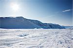 A beautiful winter landscape with a mountain and deep blue sky