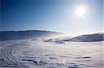 Blowing snow in a barren winter mountain landscape