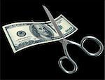One hundred dollar bill being divided with scissors for tax purposes