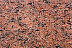 close up of a polished red marbled granite texture