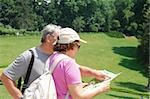 senior couple on the vacation studying a map