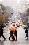 urban people cross the street on the rain