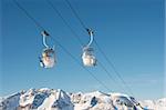 Ski lift cabins against clear blue sky