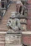 Statues of mythical beasts guarding the steps of the ancient Nyatopola Temple in Bhaktapur, Nepal