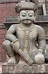 Statue of mythical person guarding the steps of the ancient Nyatopola Temple in Bhaktapur, Nepal
