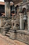 Statues of mythical beasts guarding the steps of an ancient Hindu Temple in the Durbar Square, Bhaktapur, Nepal