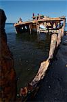 A sunken shipwreck rusting into the ocean