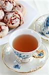 Cup of fruit tea with delicious cookies