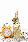 Champagne glass ready to bring in the New Year, with clock, ribbons and confetti