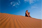 Woman admiring Coral Pink Sand Dunes State Park in Utah