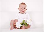 Portrait of cute newborn smiling with flowers