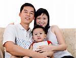 Happy Asian young father, mother and son.