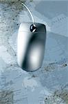 Computer silver wired mouse over blue blurred map