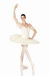 Young caucasian brunette ballerina girl on white background and reflective white floor showing various ballet steps and positions. Not Isolated