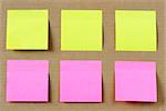 Six colored (yellow and pink) notes on cardboard