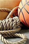 Gym corner, orange basketball ball and old rope