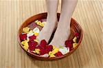 Aromatherapy, flowers woman feet bath, colorful rose petal