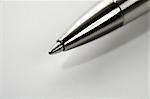 Macro roller silver gray pen point over white background